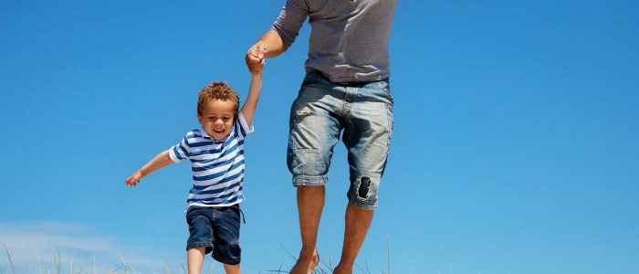 father-and-son-jumping-outdoors-PKXRS4M (1)