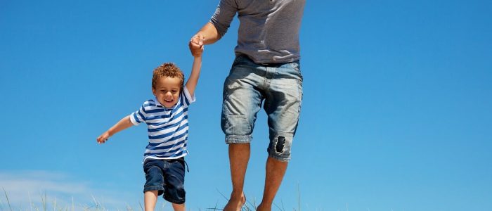 father-and-son-jumping-outdoors-PKXRS4M (1)